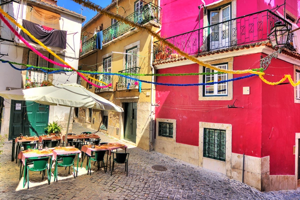 Beautiful wide angle image of the tight streets with lots of colors in Lisbon, Portugal. HDR