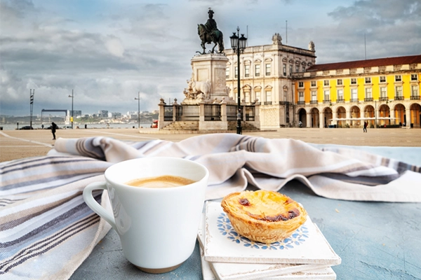 cafe with pasteles de nata and view of famous Lisbon Commerce Square, Portugal