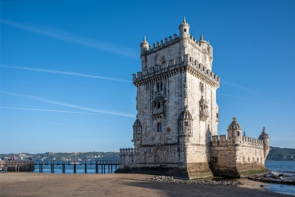 Belem tower and wooden pier during day in Lisbon, Portugal