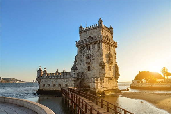 View at the Belem tower or Torre de Belem of Portuguese Manueline style on the northern bank of the Tagus River at sunset in Lisbon, Portugal
